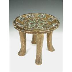 A tribal stool with inset beads of white, green and red, 30cm diameter x 27cm high Est. 100/150...