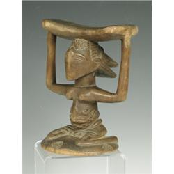 A Zulu neck rest, 2nd half 19th century, carved wood, 17cm high Est. 200/300...
