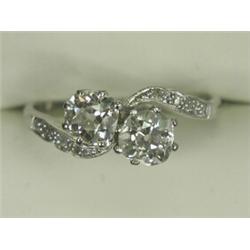 A 2-stone diamond crossover ring set with old cut stones with diamond set shoulders, in platinum,...