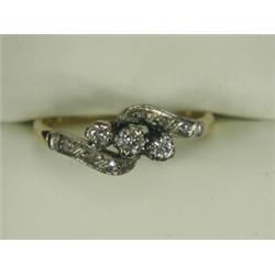 A 3-stone diamond crossover ring with diamond set shoulders, set in 18ct gold and platinum Est. 1...