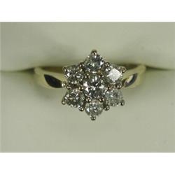 A 7-stone diamond cluster ring set in 18ct gold (total approx 1ct), size M 1/2 Est. 450/550...