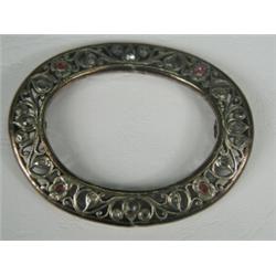 A white metal buckle set with rubies and white sapphires, 8 x 6.5mm Est. 150/200...