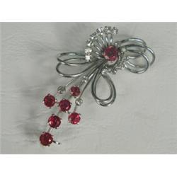 A ruby and diamond spray brooch set in white metal (tests gold), 5cm long Est. 250/300...
