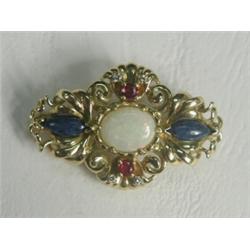 An 18ct gold brooch set with an opal, lapis lazuli, two rubies and four diamonds, 3.5cm long Est....