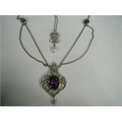 An Arts and Crafts white metal (tests silver) necklace set with amethysts (pendant 5cm long), and...