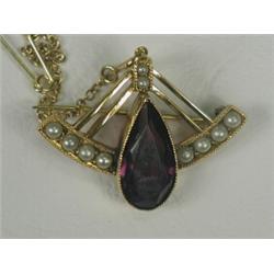 An amethyst and seed pearl brooch set in yellow metal (tests 15ct), 3cm long, with a safety chain...