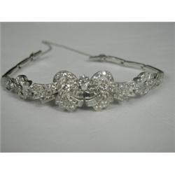 A diamond bracelet set with brilliant, eight and baguette cut stones in platinum, with a safety c...