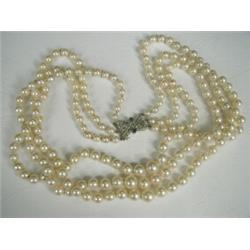 A three row graduated necklace of cultured pearls from 5.6 to 9.1mm in diameter, with a rose cut...