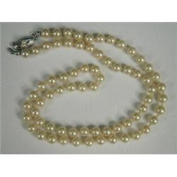 A single uniform row of 6.1mm cultured pearls with a silver clasp, 54cm long Est. 150/200...