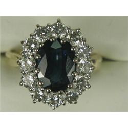 A sapphire and diamond cluster ring, the central sapphire of approx 10 x 8mm surrounded by twelve...