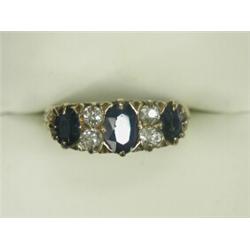 A Victorian sapphire and diamond engraved half-hoop ring set with three oval faceted sapphires an...