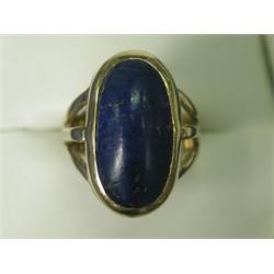 An 18ct gold ring set with a cabochon lapis lazuli (22 x 11mm), size N Est. 100/150...