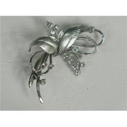 A diamond spray brooch set in white metal (tests gold), 4cm long Est. 125/175...