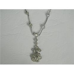 An Edwardian diamond necklace set with eighteen old cut diamonds in white metal (tests white gold...
