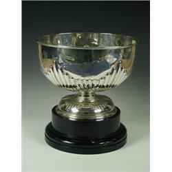 A late Victorian silver punch bowl, with a part reeded and spiral fluted body on similar round fo...