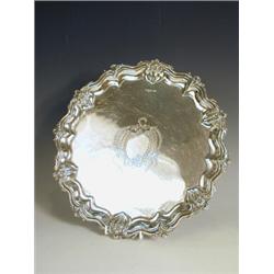 A silver salver with a shaped border, with chasing, and a rococco engraved cartouche, maker's mar...
