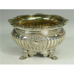 A George III silver salt with a gilt interior, the part lobed body with two applied rococo cartou...