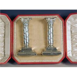 A pair of Victorian silver candlesticks, of classical form with spiral husk decoration, on steppe...