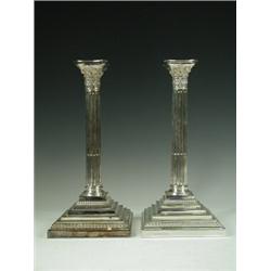A pair of modern silver candlesticks in the form of fluted corinthian columns, on stepped bases b...