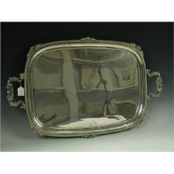 A large silver plated tray with an engraved monogram and date 1916 within cast borders, 62cm long...