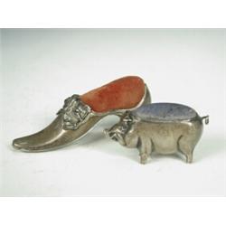 Two silver novelty pin cushions formed as a shoe and a pig, Birmingham 1891 and 1907 respectively...