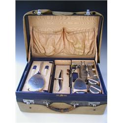A George VI lady's travelling vanity case, the removable fitted inner tray with silver backed bru...