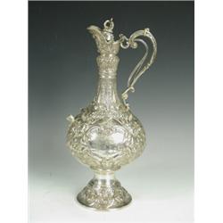 A Victorian silver Armada pattern ewer, embossed with scrolls and masks, with applied beasts head...