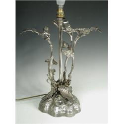 A late Victorian silver plated table lamp, modelled with a naturalistic base with stems and leave...