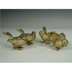 Two pairs of late 19th century Nuremburg silver gilt bird salt and peppers, each bird with a deta...