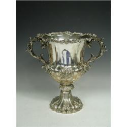 An early Victorian silver two handled cup, with repousse and applied relief foliate decoration on...