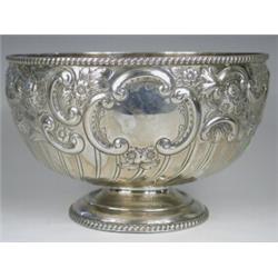 A late Victorian silver punch bowl, repousse decorated with foliage and 'c' scrolls and two vacan...