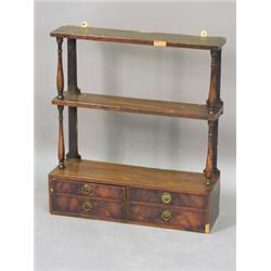 A mahogany open wall shelf, with two tiers above an arrangement of four drawers, 57 x 63.5cm Est....