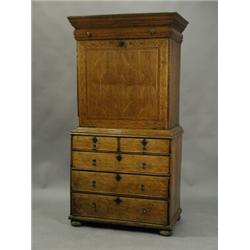 A William & Mary oak escritoire with boxwood stringing. The top section with a cushion-moulded dr...