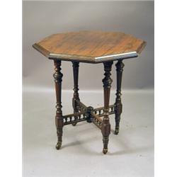 A late Victorian rosewood centre table with an octagonal top, turned and fluted legs, united by a...