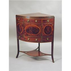 A George III inlaid mahogany corner washstand with a hinged folding top fixing to become the spla...