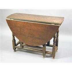 A late 17th century oak and fruitwood gateleg table, the frieze drawer missing, on turned legs, w...