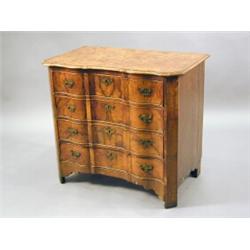 An early 19th century Dutch walnut commode, the front with four long drawers of inverted serpenti...