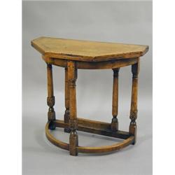 An oak Credence style table, with a fold over top and a leather inset, 81cm wide Est. 250/450...