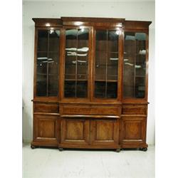 A William IV mahogany breakfront secretaire bookcase having four astragal glazed doors over three...