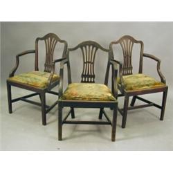 A pair of late 18th century mahogany elbow chairs and a similar chair, each with a moulded serpen...