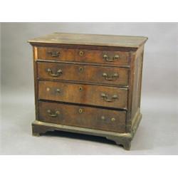 An early 18th century walnut chest, the top and drawers with crossbanding and inlaid stringing an...