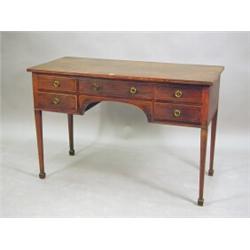 An antique mahogany kneehole table, the top with inlaid banding to the edge, and an arrangement o...