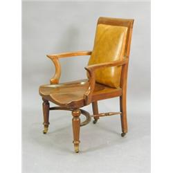 A 19th century mahogany elbow chair, with a Shoolbred, London label to seat, and a crinoline stre...