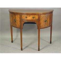 A George III style demi lune sideboard with a central frieze drawer and cupboards either side, 11...