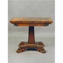 A Regency rosewood veneered fold over card table, the slender column with a base collar and a qua...