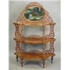 Image 1 : A Victorian burr walnut three tier whatnot surmounted with an oval mirror and with pierced fretwo...
