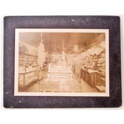 ANTIQUE MOUNTED PHOTO OF THE INSIDE OF A GENERAL STORE