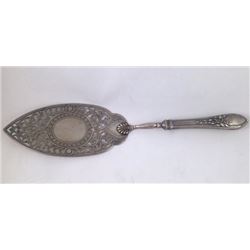 A silver carved and engraved tart picker- Signed and