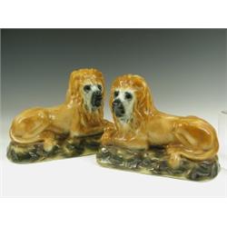 A pair of Staffordshire lions probably Scottish c.1920, two glass eyes missing, one cracked, 3...