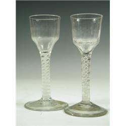 Two 18th Century wine glasses with panelled ogee bowls on double strand opaque twist stems, ch...